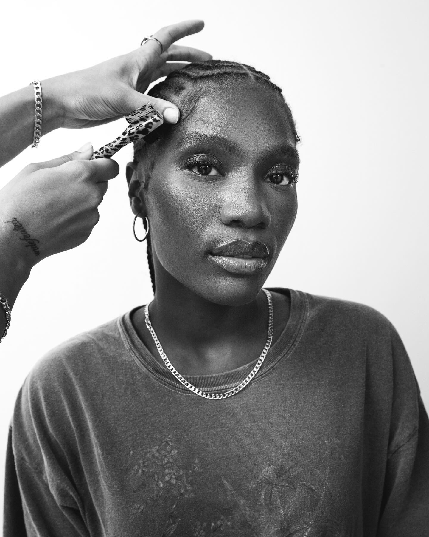 Black-and-white portrait of a woman having her edges brushed
