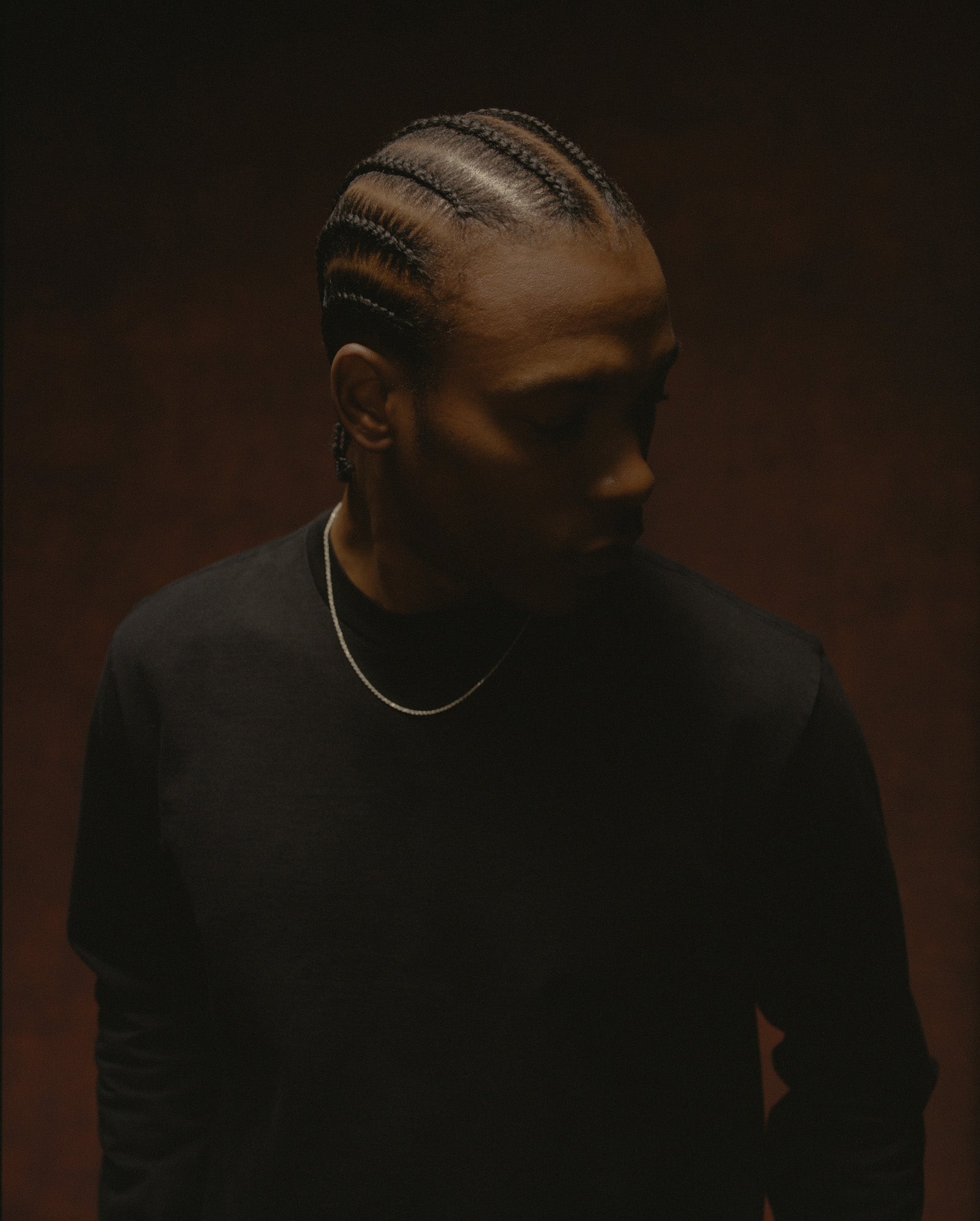 Young Vets close portrait in a black T-shirt with braided hair